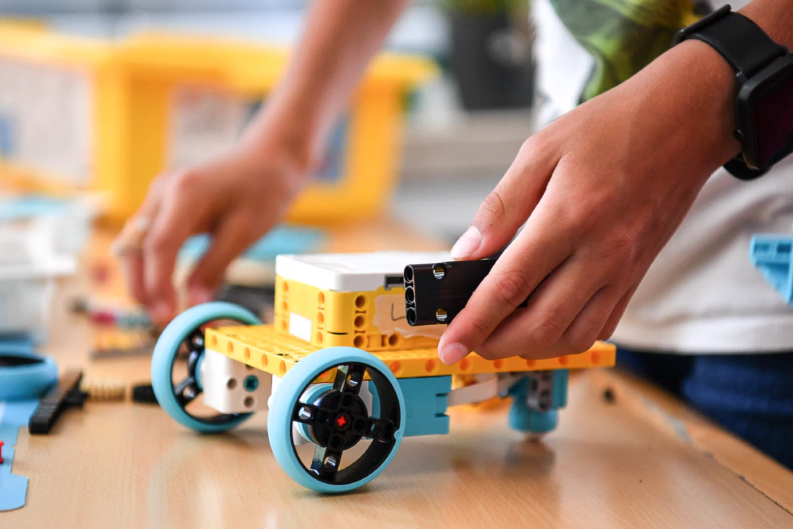 Close-up of a LEGO Spike Prime robot being assembled in the course